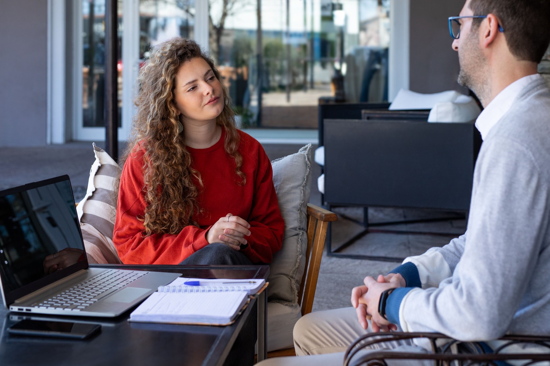Young woman at her first job interview with the owner of a coffee shop